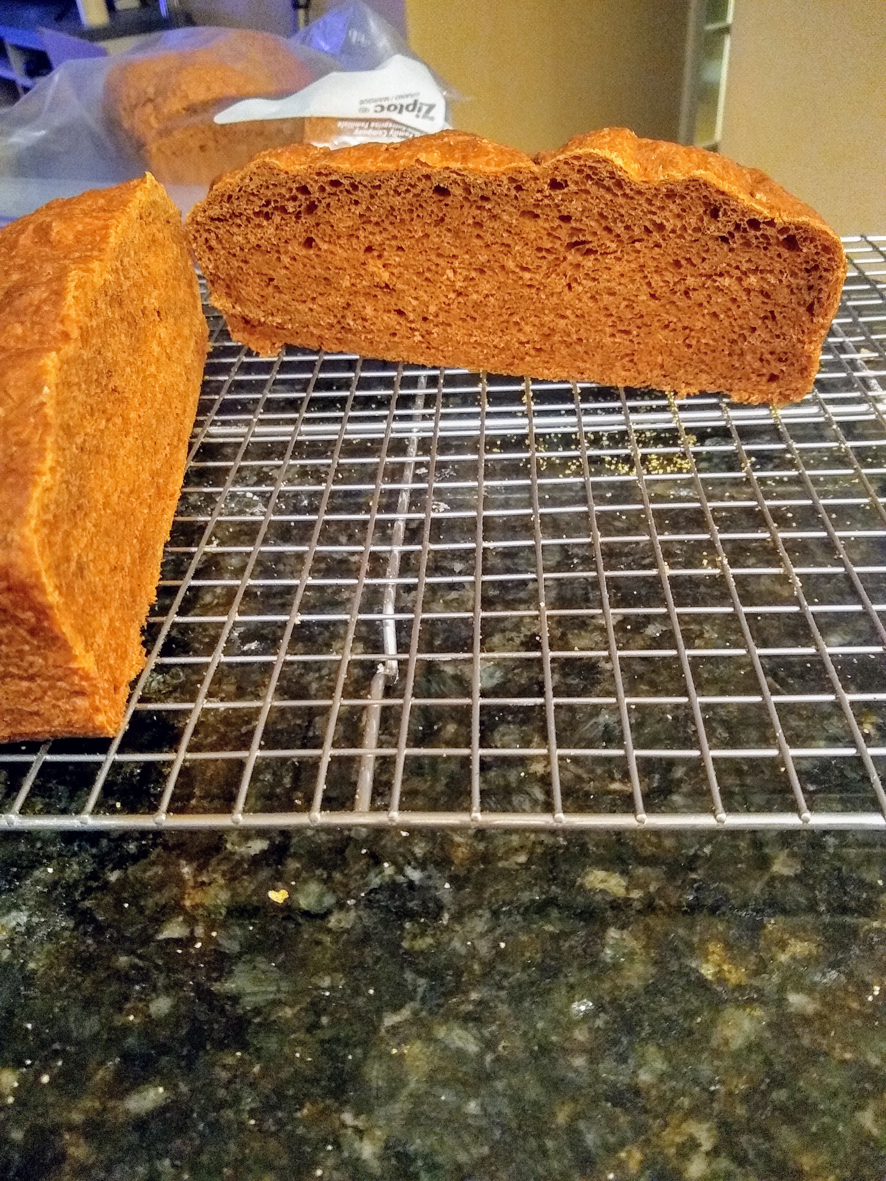 Cross-section of pumpernickel loaf showing the dense crumb at the bottom.