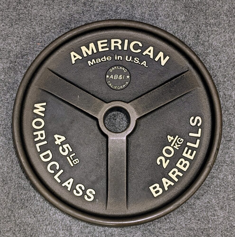 American World Class Barbells 45 lb plate, black with raised white lettering and AB&I Oakland foundry mark
