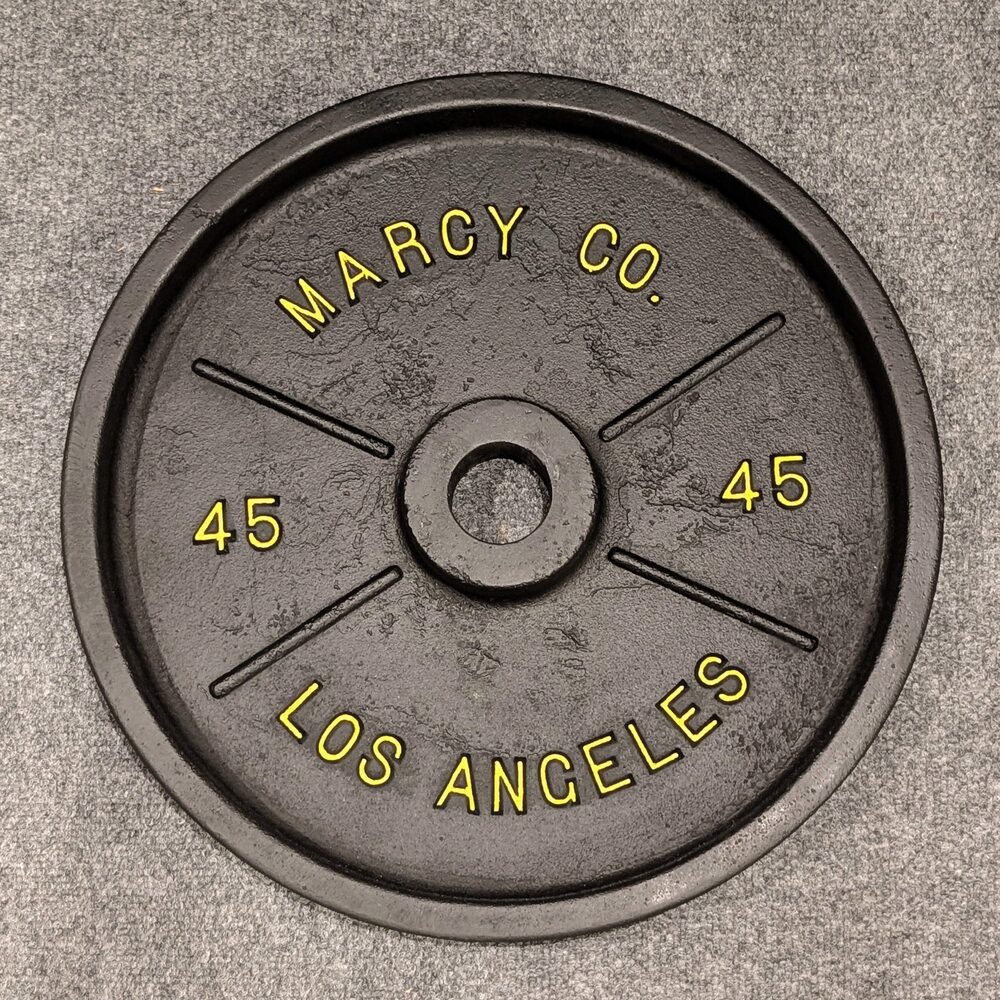 Marcy Co. Los Angeles 45 lb plate with yellow lettering and slash-mark web